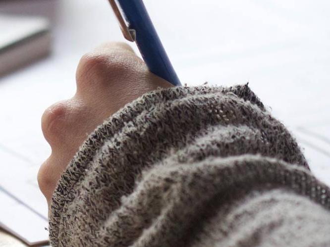 Student is writing with pen